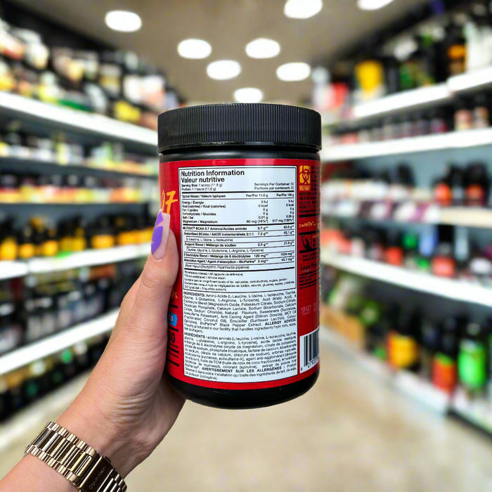Close-up of (Mutant BCAA 9.7 with Micronized Amino Acid and Electrolyte Support Stack) held up inside My Supplement Shop, clearly showing key ingredients on the packaging in a Sports Nutrition setting.
